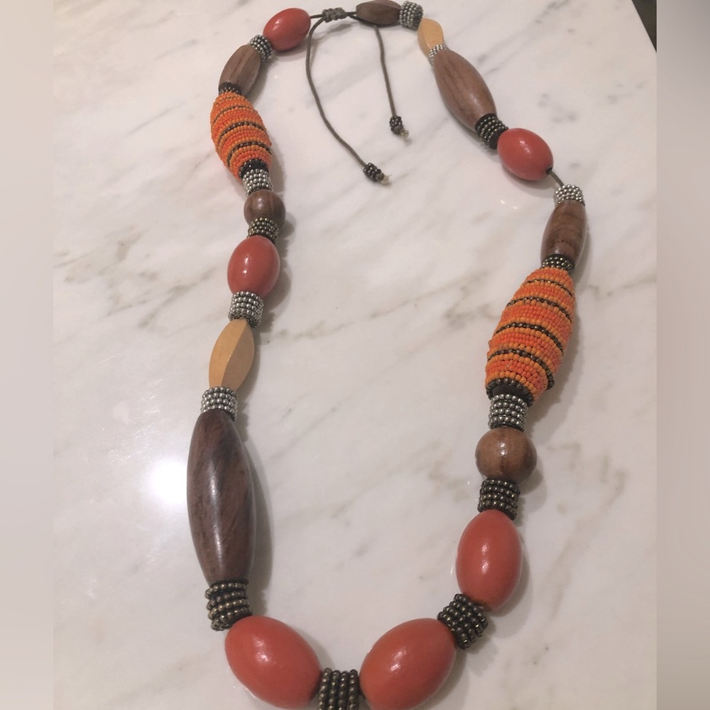 Artisan made wood and orange bead necklace strung by hand on leather